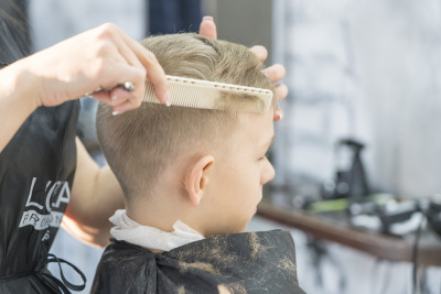 a-boy-getting-his-haircut-at-the-barber-shop-2021-08-29-01-17-54-utc